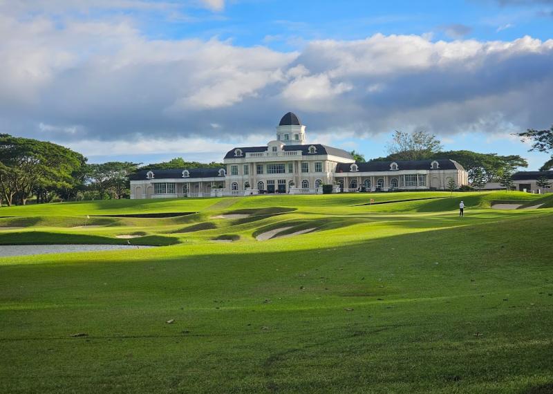Summit Point golf fairway view with turquoise sky and palace in the background