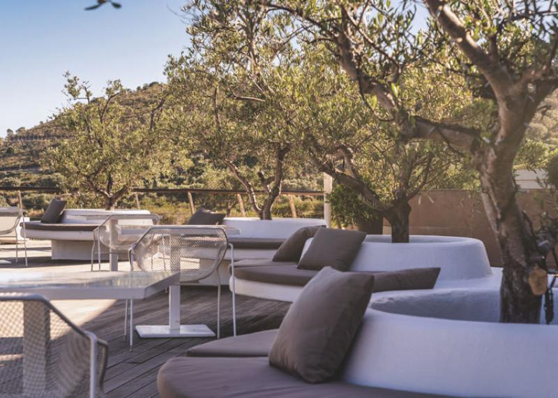 Argentario resort rooftop terrace with sofas, tables and plants