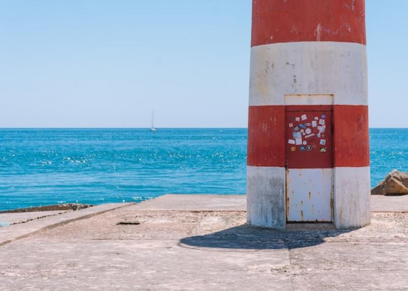 lighthouse with sea in the background