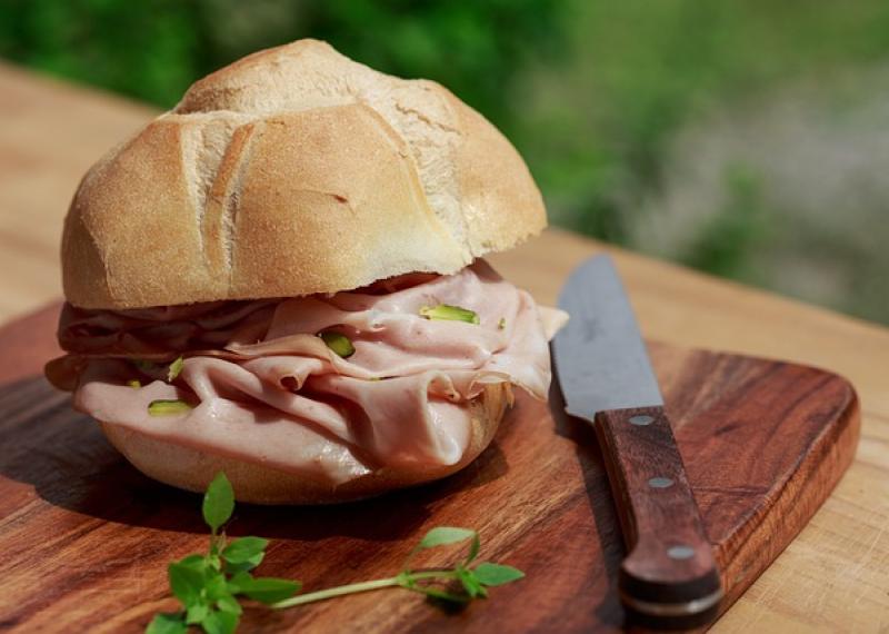 sandwich with bologna on a cutting board