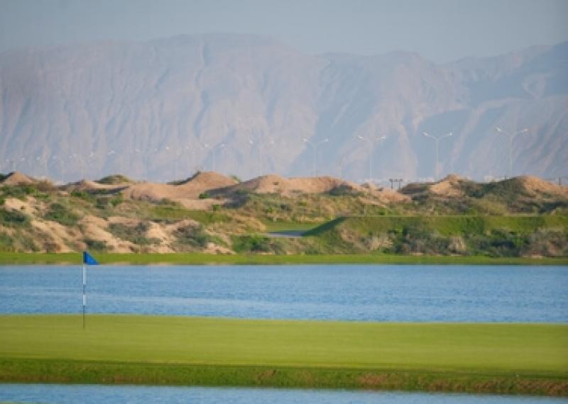 Green and water obstacles at Al Mouj Golf
