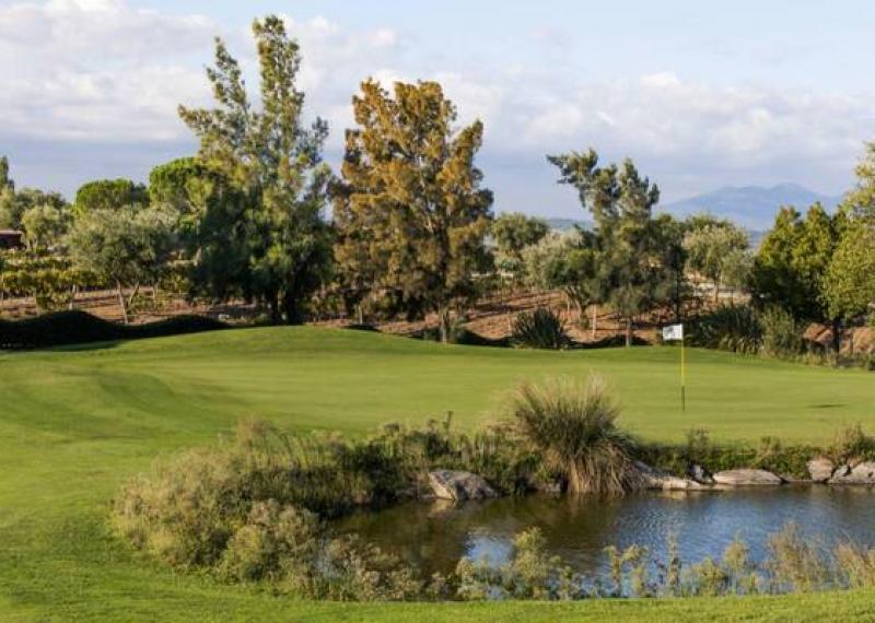 Green with hole and water obstacle at Peralada Golf Club