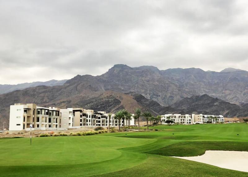 Jebel Sifah Golf Course green and surrounding buildings view
