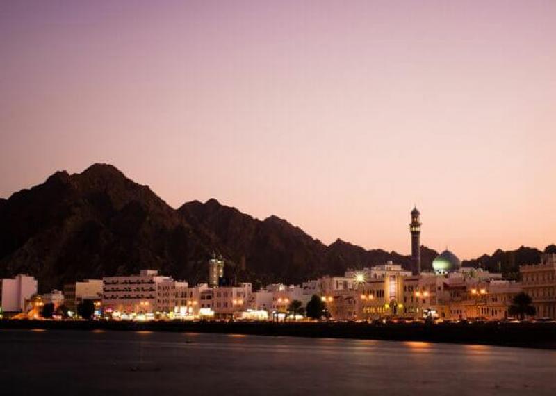 Muscat at sunset seen from the sea