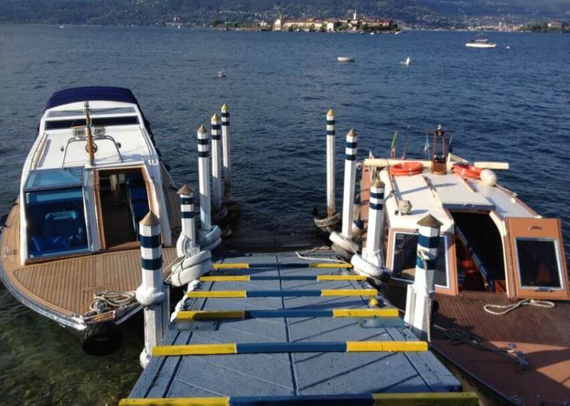 Boats docked on the shore of Lake Maggiore