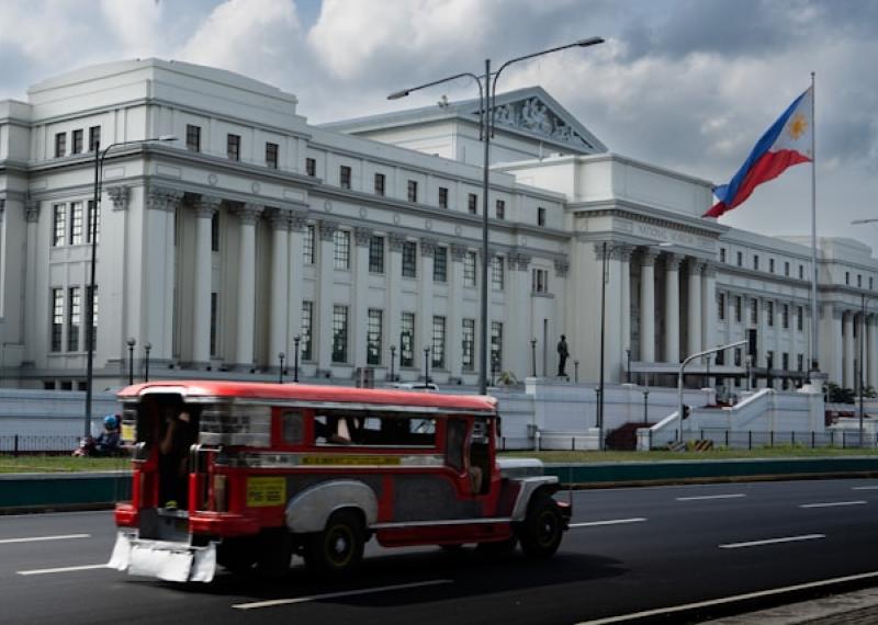 Manila palace with street and typical bus